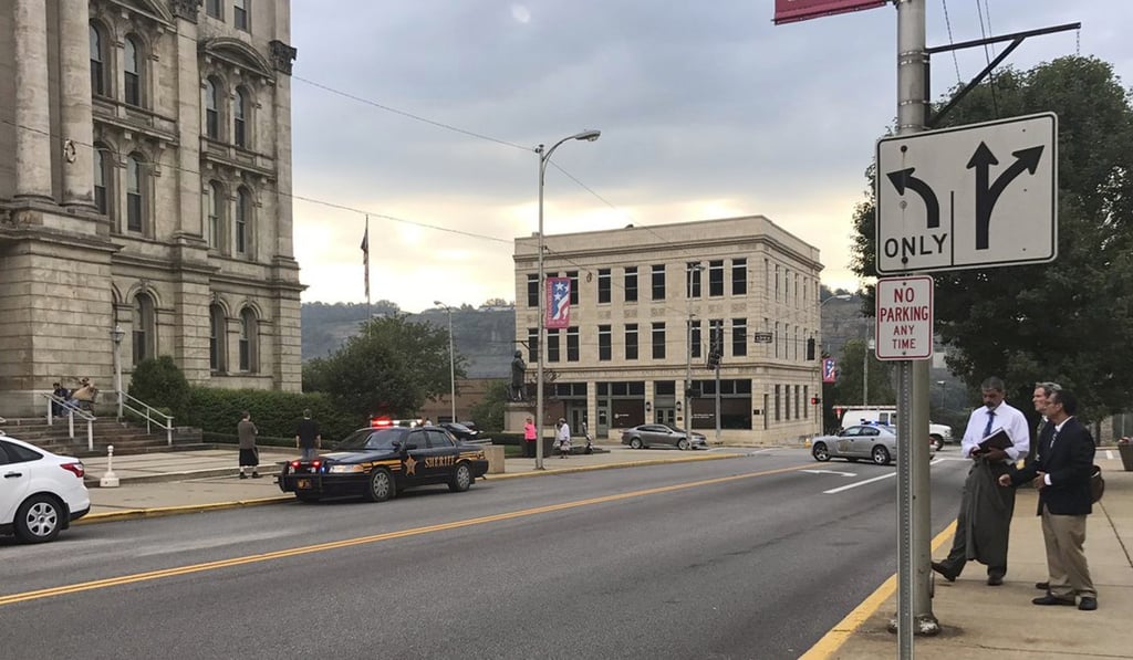 A police vehicle responds to the ambush-style shooting of Jefferson County Judge Joseph Bruzzese Jnr as he walked toward the Jefferson County Courthouse. Bruzzese was wounded and the suspect was killed after the judge and a probation officer returned fire, officials said. Photo: AP A police vehicle responds to the ambush-style shooting of Jefferson County Judge Joseph Bruzzese Jnr as he walked toward the Jefferson County Courthouse. Bruzzese was wounded and the suspect was killed after the judge and a probation officer returned fire, officials said. Photo: AP