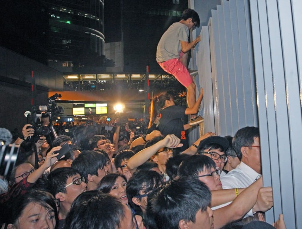 Protesters try to storm the “Civic Square” forecourt outside the government headquarters in Admiralty, on September 26, 2014. Photo: SCMP Pictures