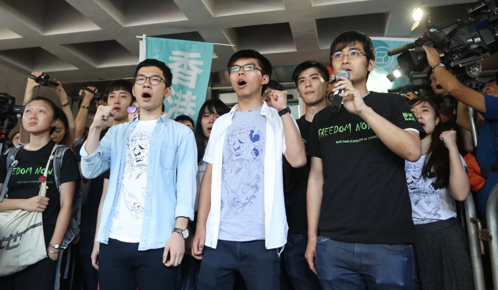 Demosisto chairman Nathan Law (left), the party’s secretary general Joshua Wong (centre) and non-affiliated activist Alex Chow received jail terms of between six and eight months. Photo: Edward Wong