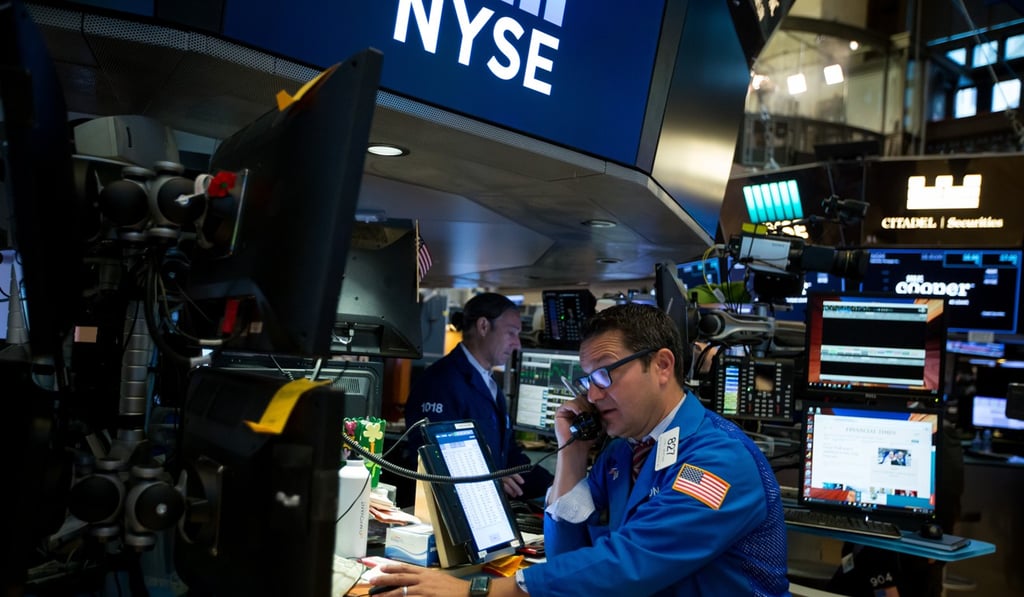 A trader talks on the phone while working on the floor of the New York Stock Exchange. Photo: Bloomberg A trader talks on the phone while working on the floor of the New York Stock Exchange. Photo: Bloomberg