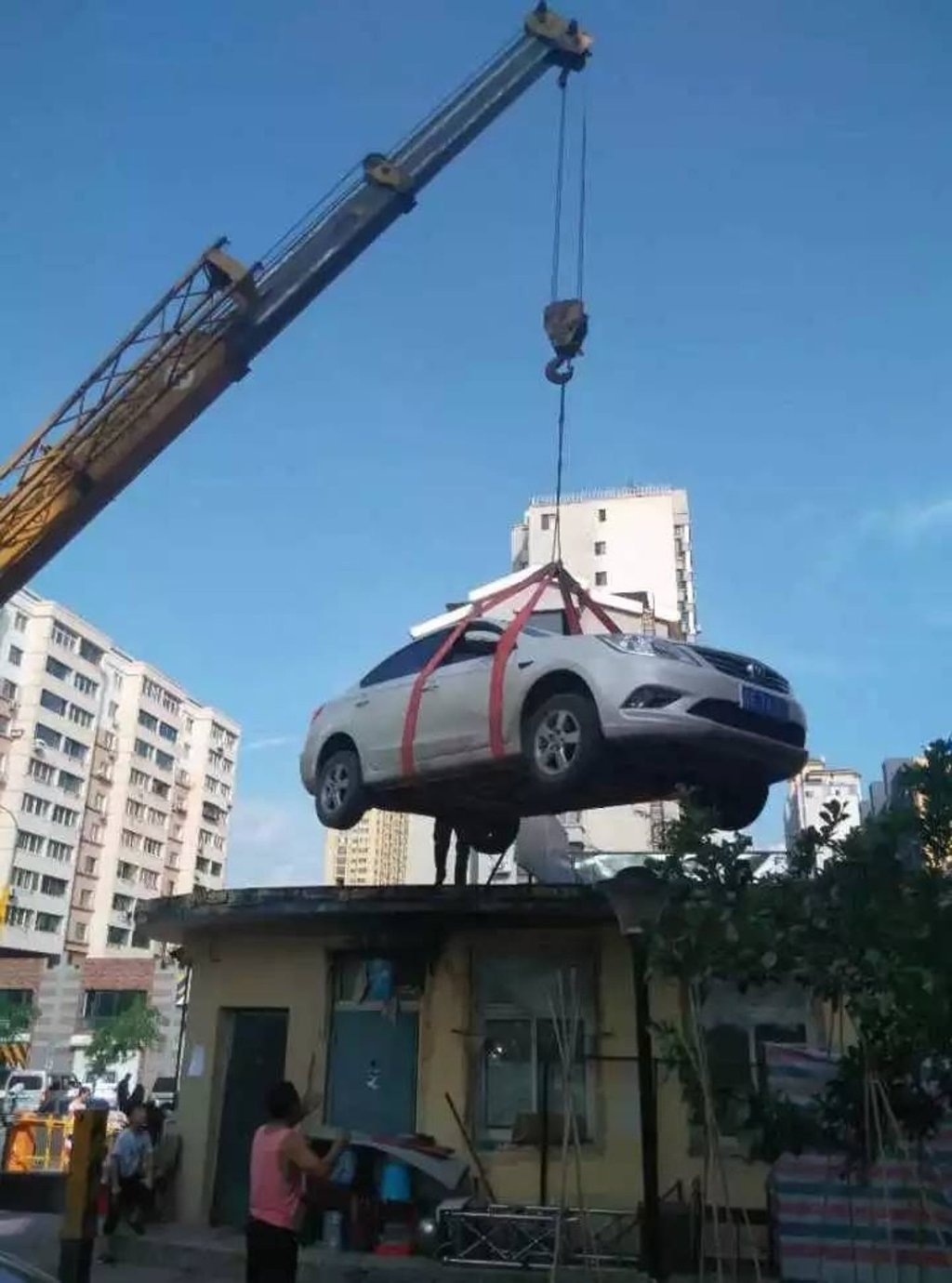 The crane was hired to move the car after it blocked traffic entering the housing estate for about two hours. Photo: Handout