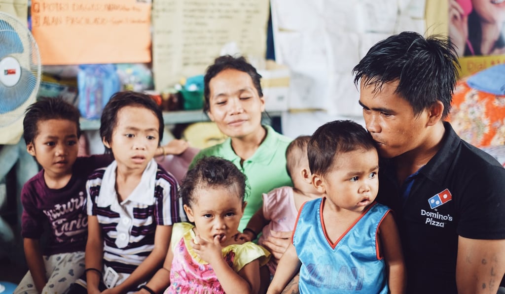 Ali Nur, wife Orick and their five young children. Photo: Karim Raslan Ali Nur, wife Orick and their five young children. Photo: Karim Raslan