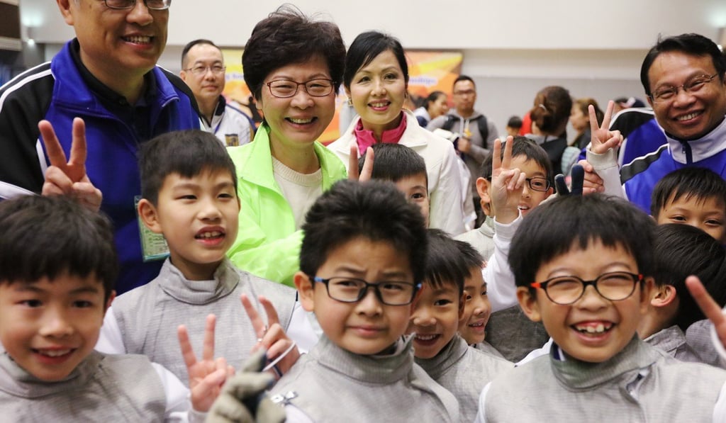 Then chief executive hopeful Carrie Lam with primary and secondary principals and students, ahead of a meeting with school officials, at Lam Tai Fai College in Sha Tin on February 19. Photo: Felix Wong