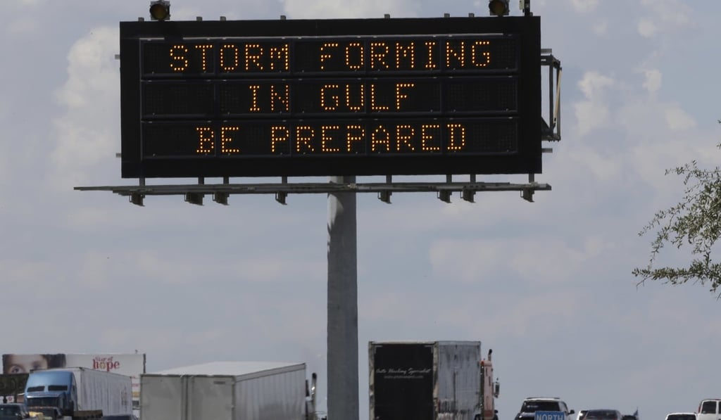Motorists in Houston pass a sign warning of Hurricane Harvey as the storm intensifies in the Gulf of Mexico. Photo: AP Motorists in Houston pass a sign warning of Hurricane Harvey as the storm intensifies in the Gulf of Mexico. Photo: AP