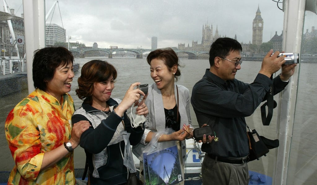 Chinese tourists enjoy a cruise on the River Thames in London. Photo: Reuters
