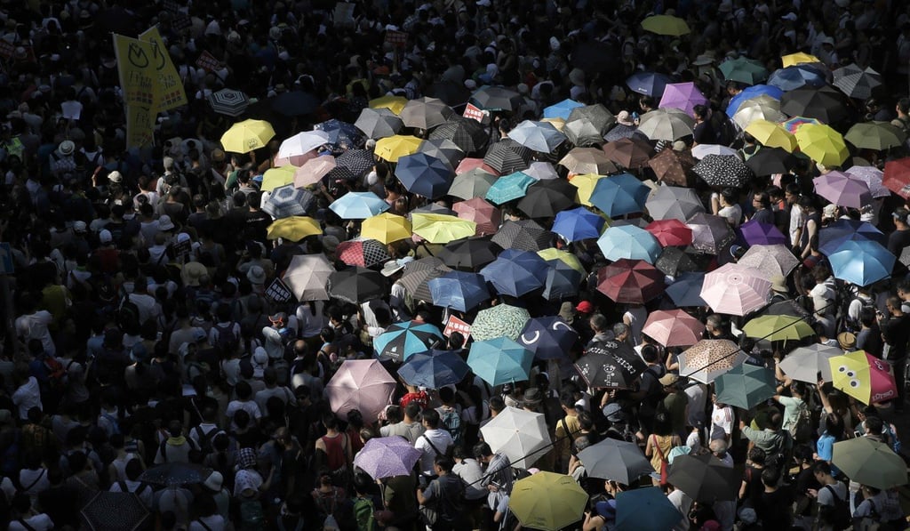 Protesters attend a rally to support young activists Joshua Wong, Nathan Law and Alex Chow. Photo: AP Photo