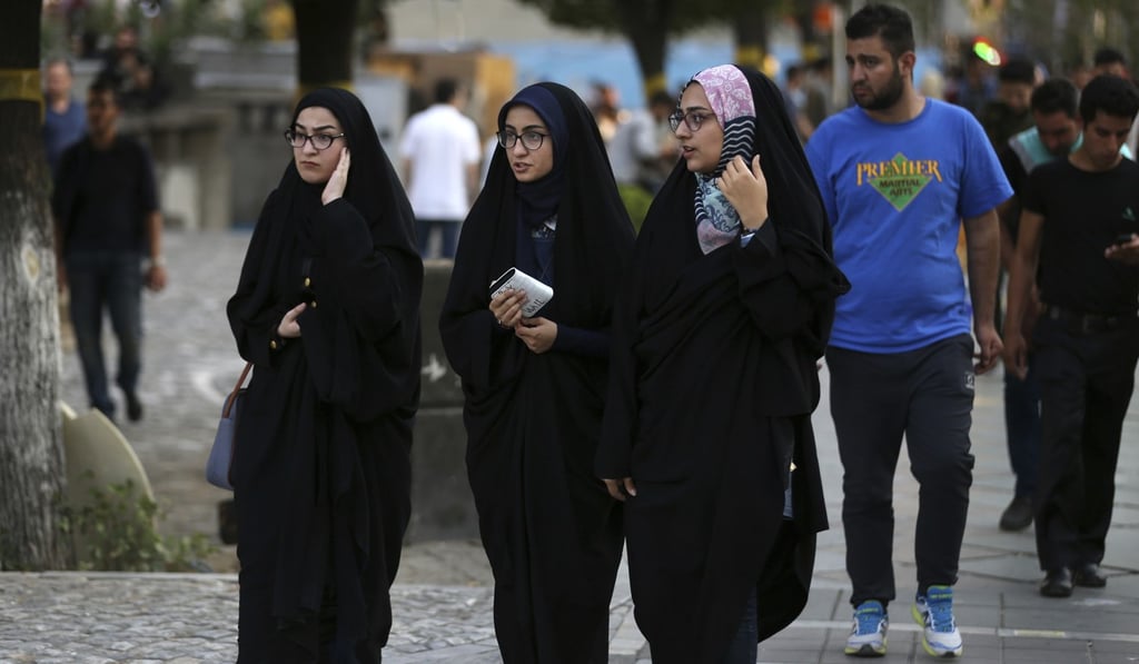 Iranian women walk down the street in downtown Tehran wearing the traditional chador. Photo: AP Iranian women walk down the street in downtown Tehran wearing the traditional chador. Photo: AP