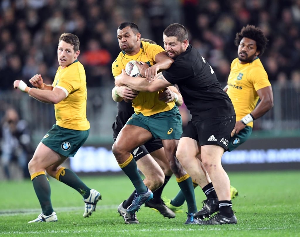 Kurtley Beale of Australia held by Dane Coles of New Zealand. Photo: EPA