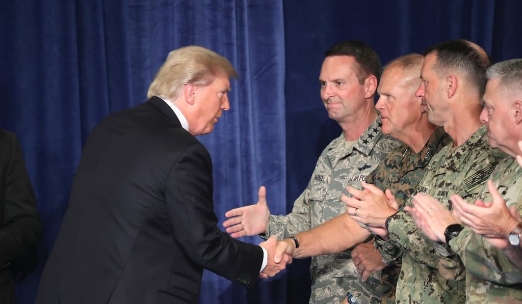 President Donald Trump greets military leaders before his speech on Afghanistan. Photo: EPA