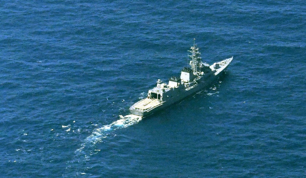 A Japanese warship searches for the missing crew. Photo: Kyodo