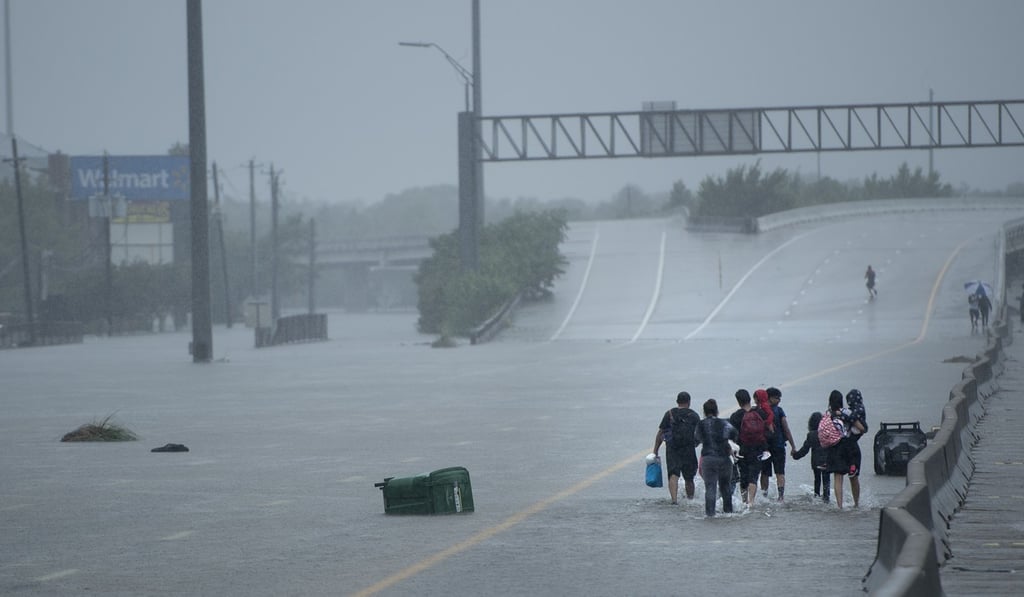 Evacuated residents walk for help amid the aftermath of Tropical Storm Harvey in Houston on Sunday. Photo: AFP Evacuated residents walk for help amid the aftermath of Tropical Storm Harvey in Houston on Sunday. Photo: AFP