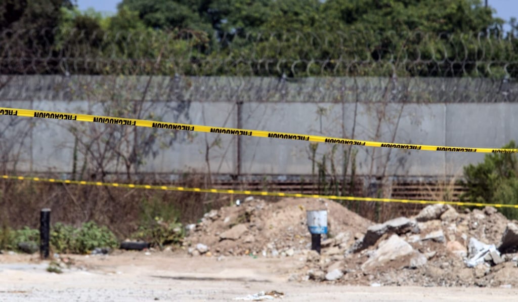 Police lines surround a warehouse in Tijuana, Mexico, at the entrance of a tunnel used to smuggle Chinese nationals into the USthat was discovered on Sunday. Photo: AFP