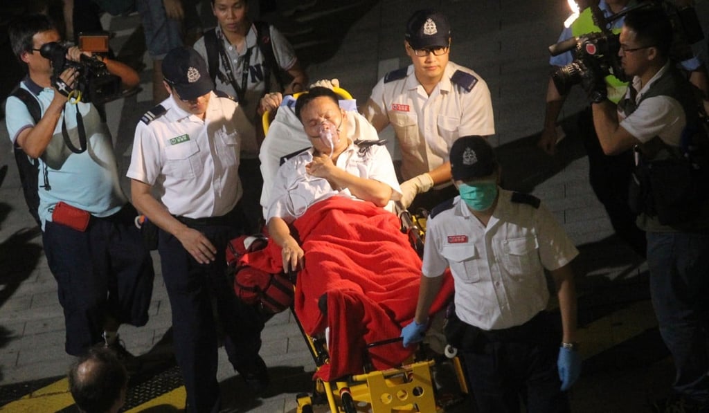 A security officer hurt during the melee on September 26 is taken to hospital. Photo: May Tse