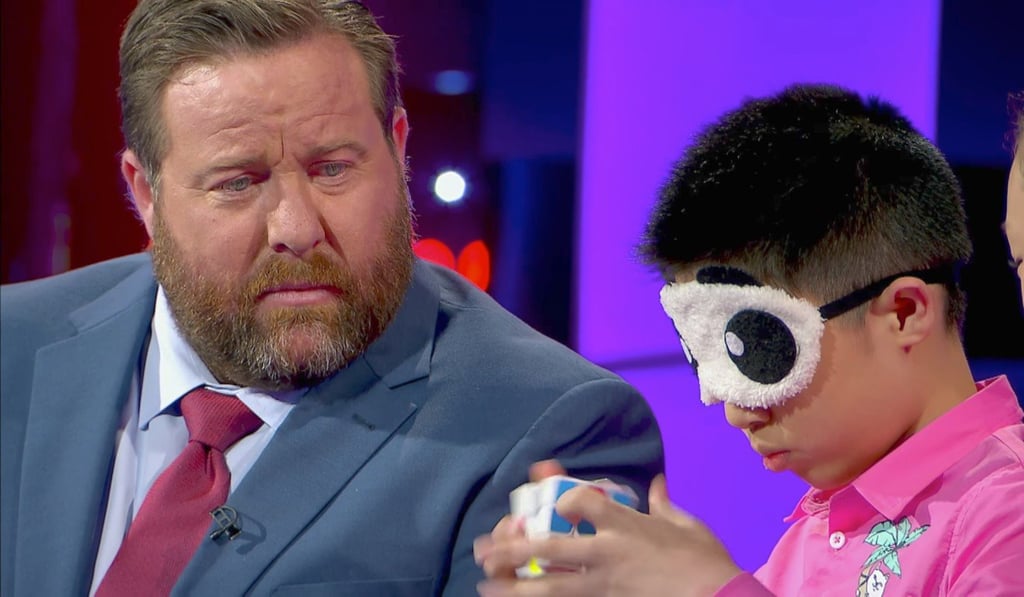 Que also completed the puzzle blindfolded, watched on by host Shane Jacobson. Photo: Handout