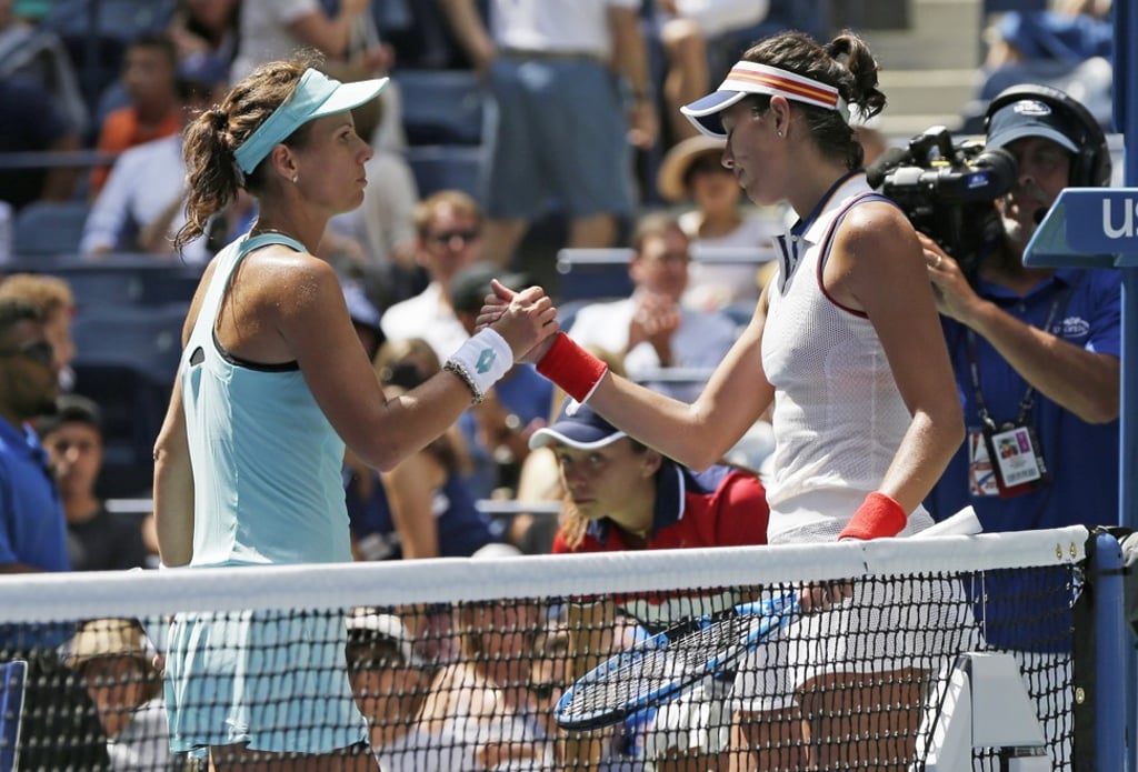 Varvara Lepchenko congratulates Garbine Muguruza after their first round match of the US Open. Photo: AP