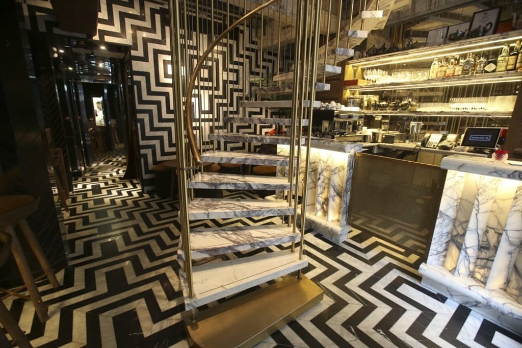 A spiral staircase leads to the upstairs restaurant and bar. Photo: David Wong