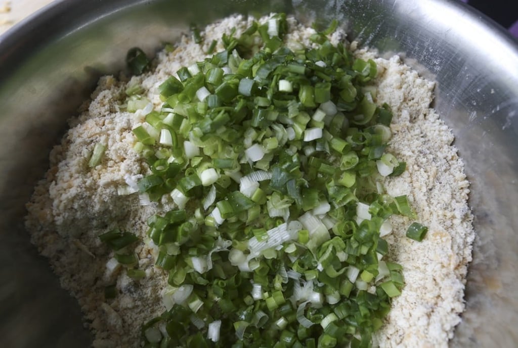 Add the mustard, cheese and spring onions to the flour mixture.