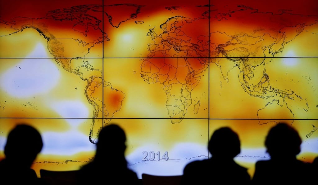 Participants look at a screen showing a world map with climate anomalies during the World Climate Change Conference 2015 at Le Bourget, France in December 2015. Photo: Reuters