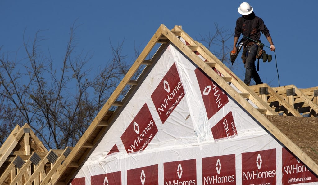 A construction worker installing a rooftop on to a new home being built in Fairfax, Virginia. The US economy’s second quarter GDP was revised higher by Washington. Photo: AFP A construction worker installing a rooftop on to a new home being built in Fairfax, Virginia. The US economy’s second quarter GDP was revised higher by Washington. Photo: AFP