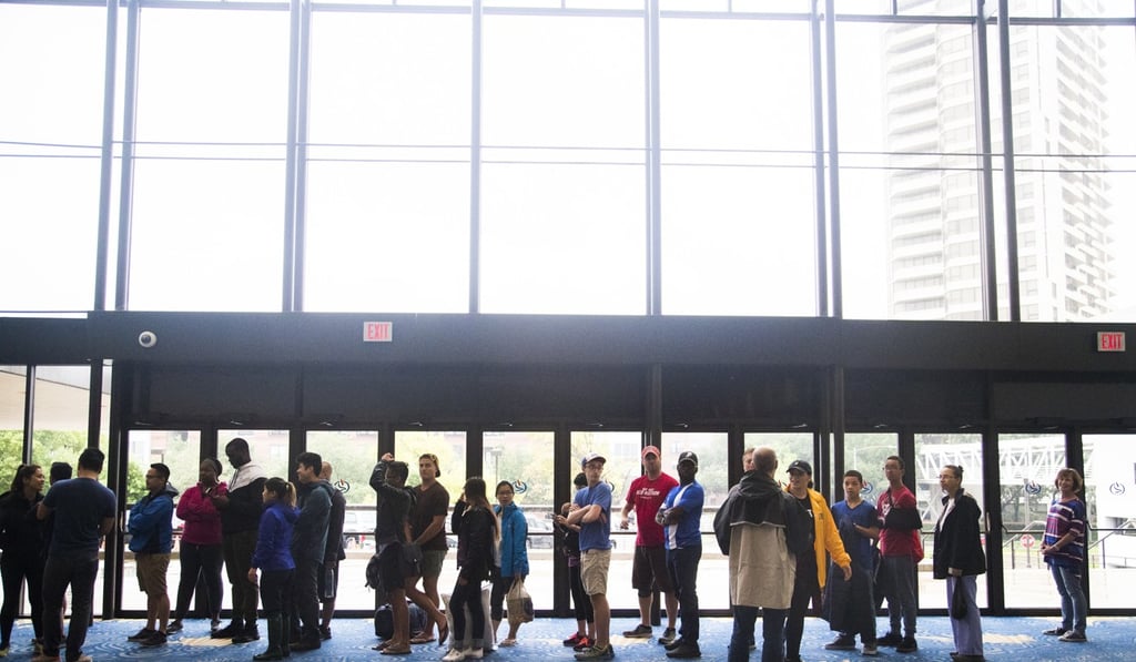 A long line of volunteers forms to check into the Lakewood Church to help evacuees on Tuesday. Photo: AP