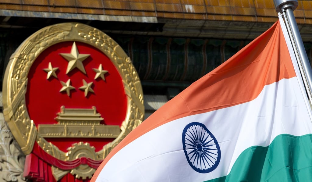 An Indian national flag and the Chinese national emblem at the Great Hall of the People in Beijing. Photo: AP