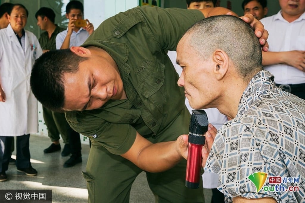 A hospital worker gives Xu a shave on his arrival at the hospital. Photo: Handout