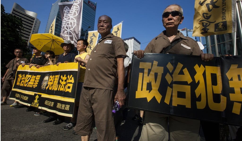 Hong Kong people march through the streets wearing prison uniforms in support of jailed activists Joshua Wong, Nathan Law and Alex Chow, on the Sunday following the judgment. The fact that some 20,000 people demonstrated that day without incident or arrest is the best proof that freedoms in Hong Kong are intact. Photo: EPA Hong Kong people march through the streets wearing prison uniforms in support of jailed activists Joshua Wong, Nathan Law and Alex Chow, on the Sunday following the judgment. The fact that some 20,000 people demonstrated that day without incident or arrest is the best proof that freedoms in Hong Kong are intact. Photo: EPA
