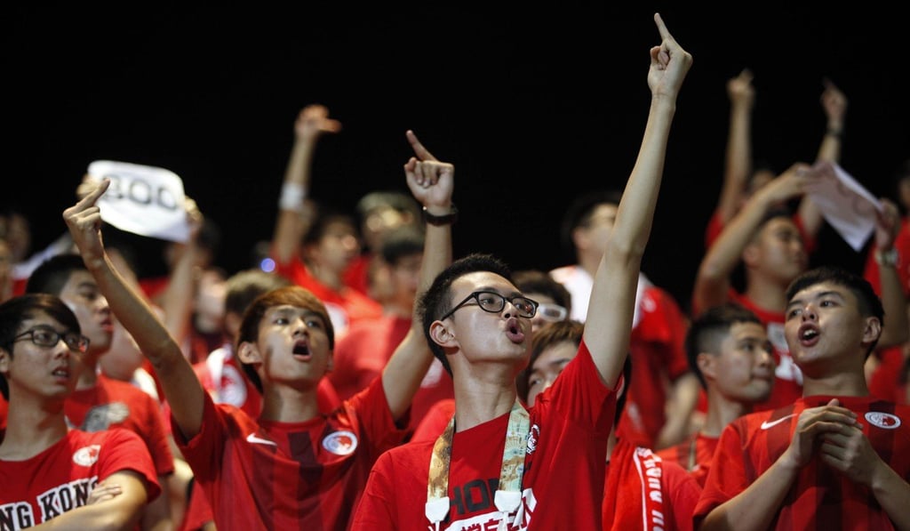 Hong Kong fans gesture as the Chinese football team takes to the pitch during the World Cup qualifier in Hong Kong on November 17, 2015. Photo: AFP