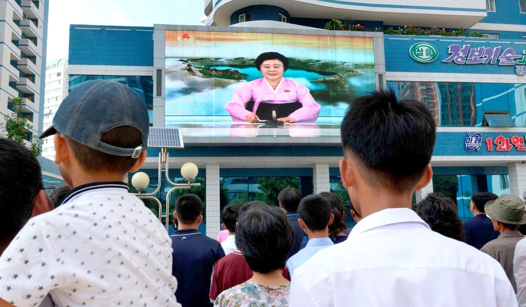 North Koreans watch a news report announcing the nuclear test on September 3, 2017. Photo: Kyodo/Reuters