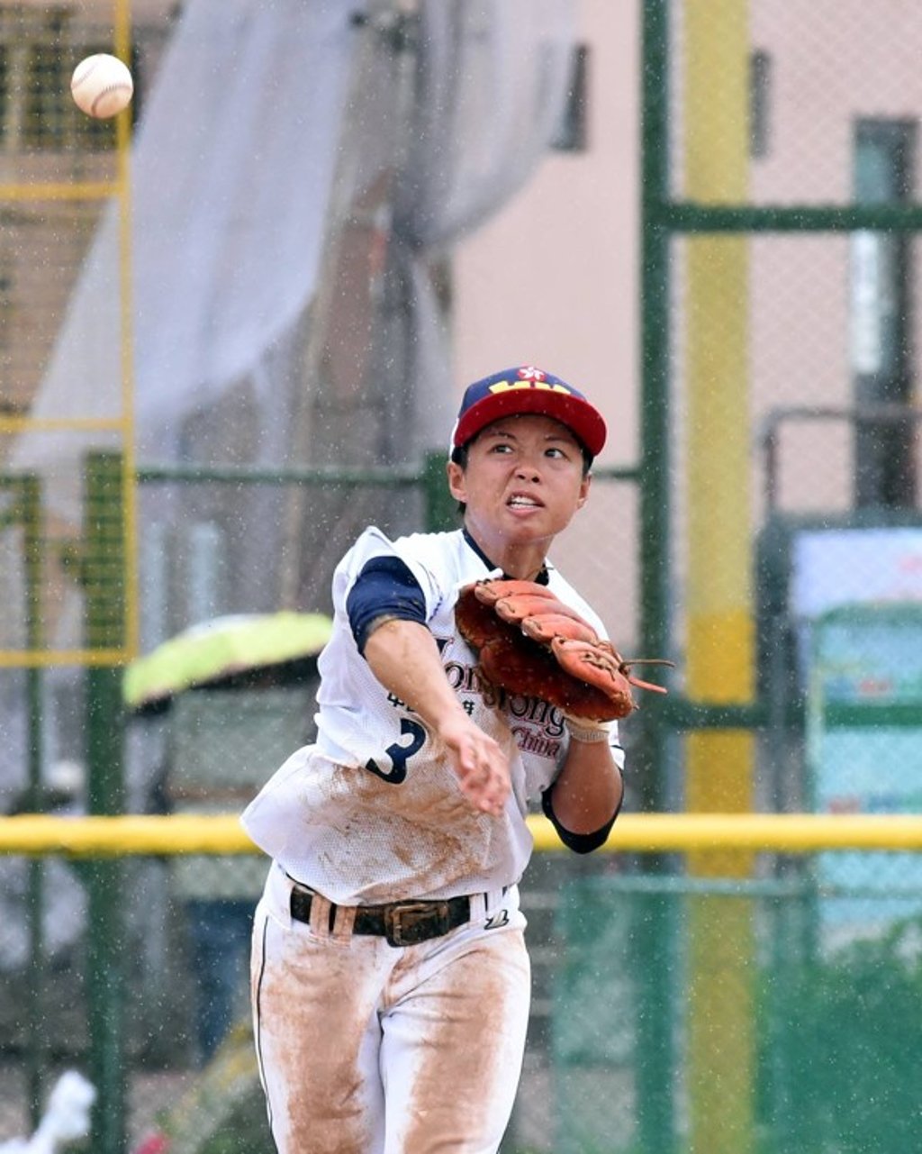 Pitcher Lau Tsz-chin throws the ball as Hong Kong struggle to match Chinese Taipei in the rain. Pitcher Lau Tsz-chin throws the ball as Hong Kong struggle to match Chinese Taipei in the rain.