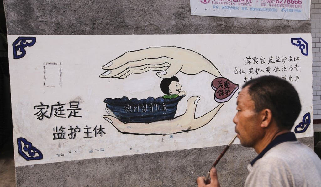 A man studies a mural in Cizhu reminding residents that the family is the main source of care for children. Photo: Simon Song