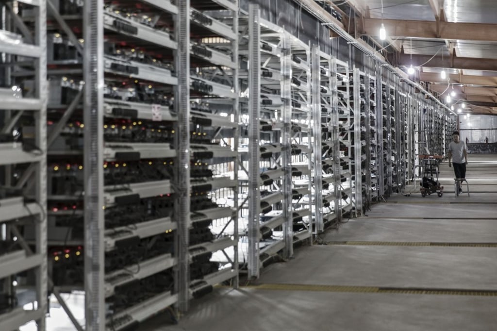 A technician inspects bitcoin encryption, or “mining”, machines at a facility in China. Photo: Bloomberg