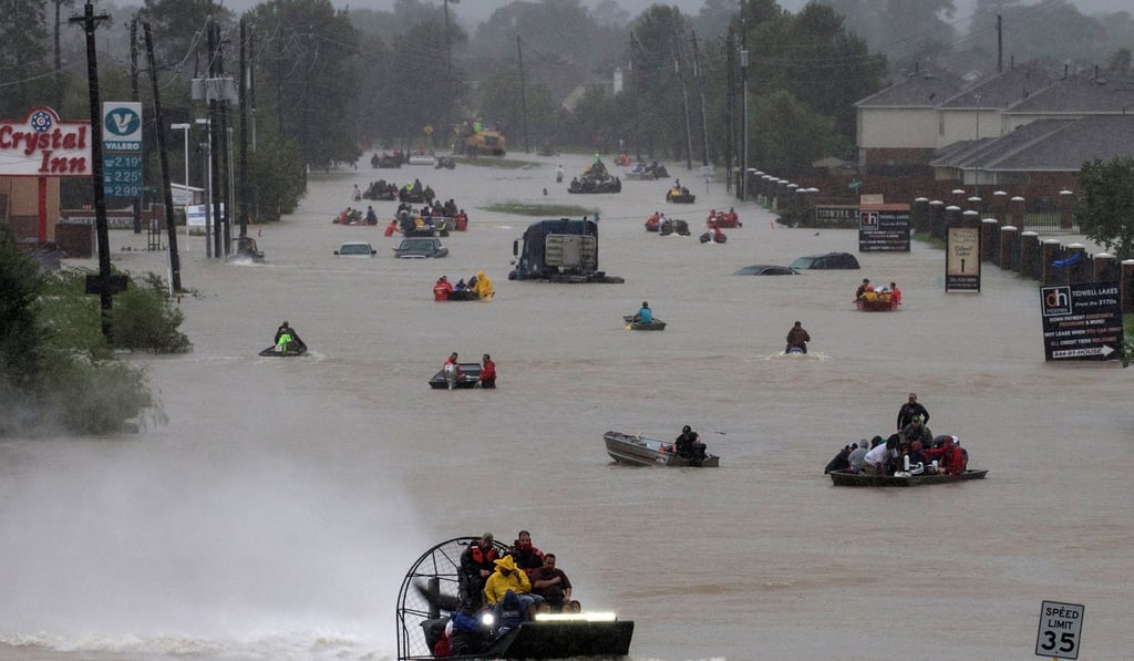 Residents use boats to evacuate flood waters from Hurricane Harvey in Houston. Photo: Reuters/Adrees Latif TPX