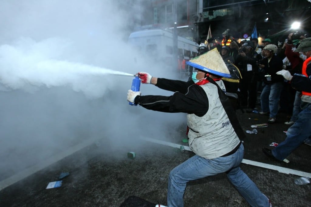 Riot police and anti-WTO protesters fight over a riot shield near the Hong Kong Convention & Exhibition Centre on December 17, 2005. Hundreds of protesters fought riot police in the most violent demonstrations since trade ministers from around the world began meeting in Hong Kong. The running street battles involved South Korean farmers, Southeast Asian groups and European activists who oppose the World Trade Organization's efforts to remove trade barriers. Photo: SCMP