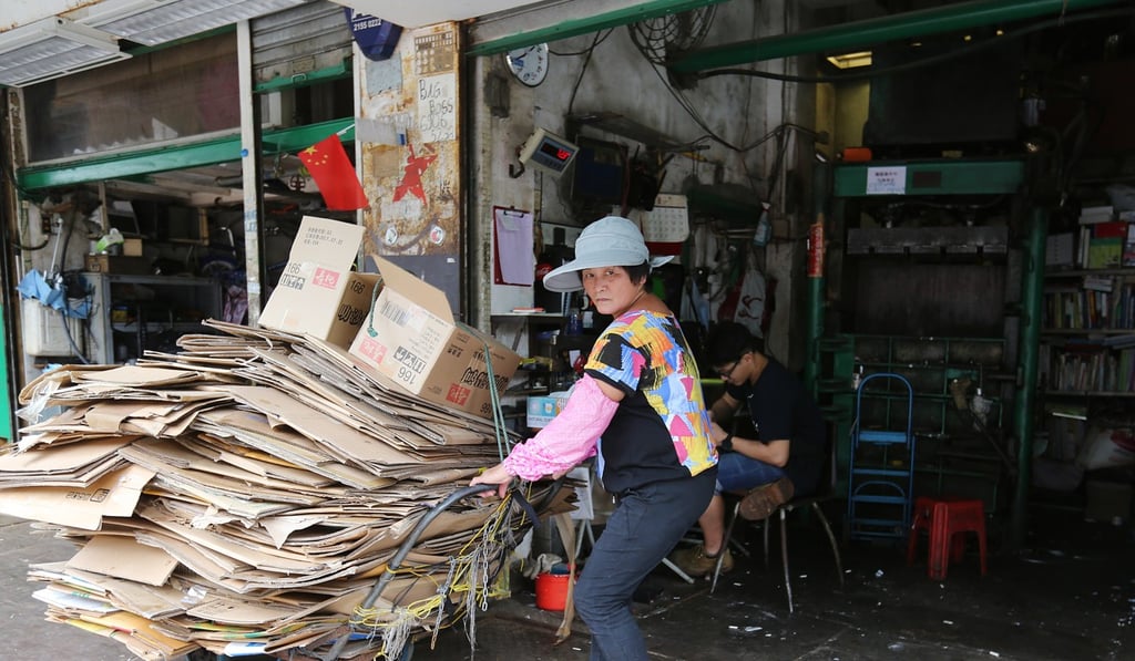 A woman sells papers to Hing Lee Recycle Shop in Quarry Bay. Photo: Xiaomei Chen