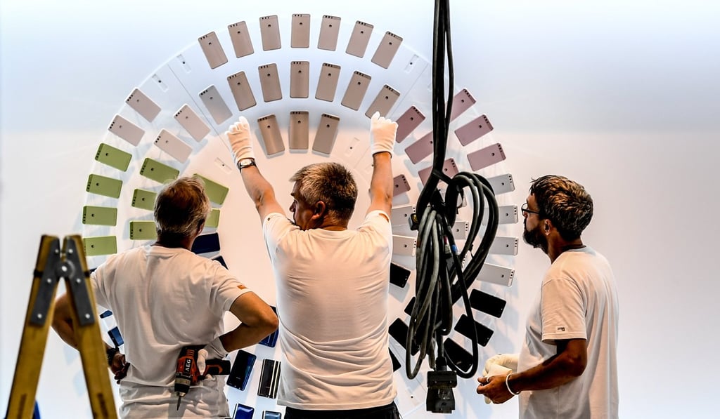 Workers adjust a panel at the Huawei stand of the Internationale Funkaustellung Berlin, an international consumer electronics fair, in Berlin, Germany in August. The company enjoys strong sales in Europe, Latin America and the Middle East, as well as domestically. Photo: EPA
