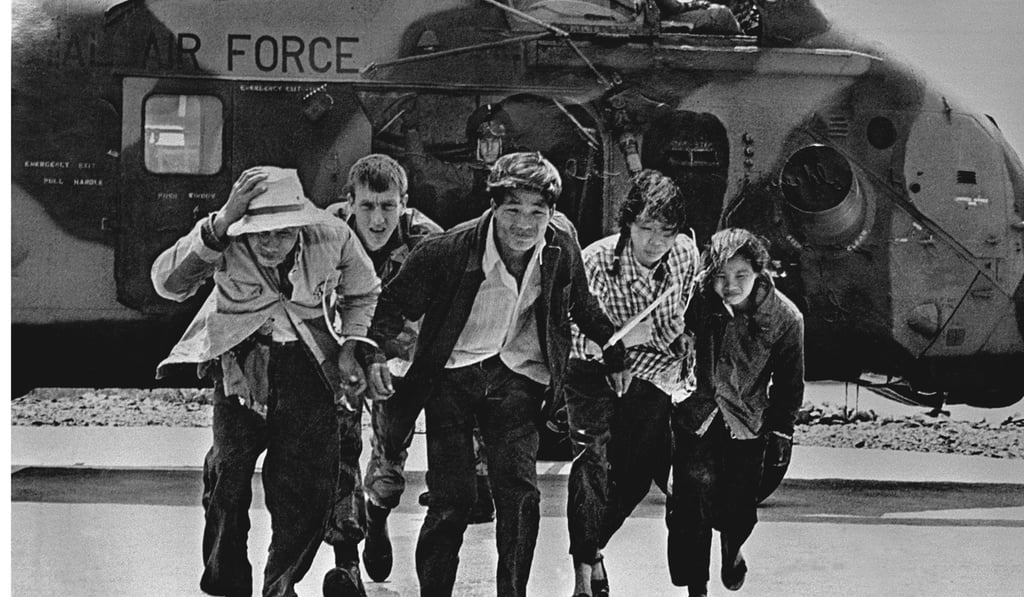 Picked up on a remote stretch of coast, this illegal immigrant family is shepherded from an RAF Wessex helicopter in Hong Kong by an airman in this undated Post archive photograph.