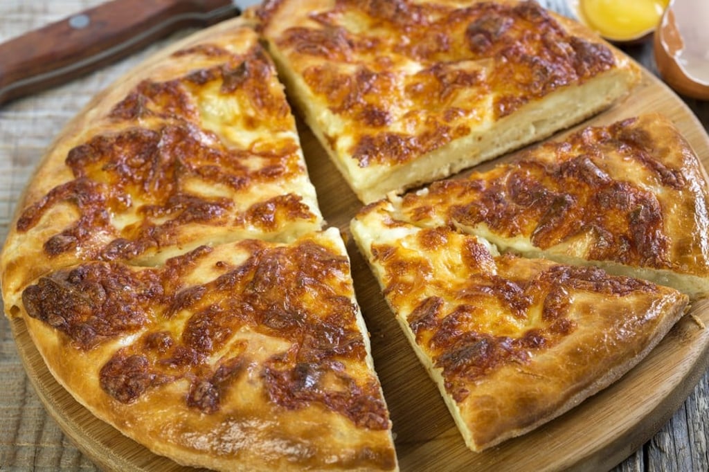 Georgia’s national dish is khachapuri, an utterly decadent bread that is topped, but also filled, with different cheeses. Photo: Alamy