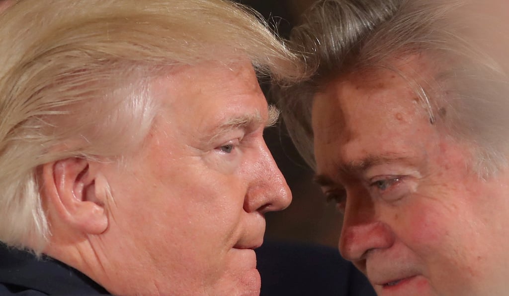 US President Donald Trump talks to chief strategist Steve Bannon during a swearing in ceremony for senior staff at the White House. Bannon has left his post and is attacking aides he believes are disloyal to Trump. Photo: Reuters