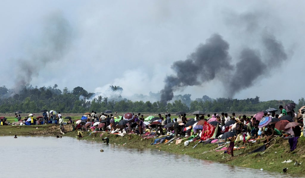 Smoke billows above a burning village in Myanmar’s Rakhine state as Rohingya shelter in a no-man’s land between Bangladesh and Myanmar. Photo: AFP