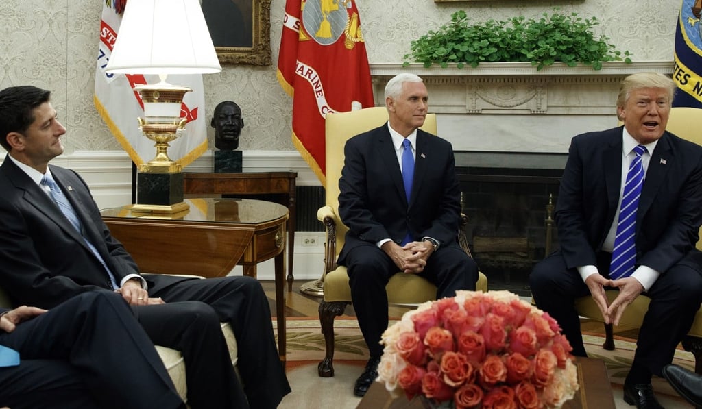 House Speaker Paul Ryan of Wisconsin, left, and Vice President Mike Pence, centre, listen as President Donald Trump speaks during a meeting with Congressional leaders in the Oval Office of the White House. Photo: AP