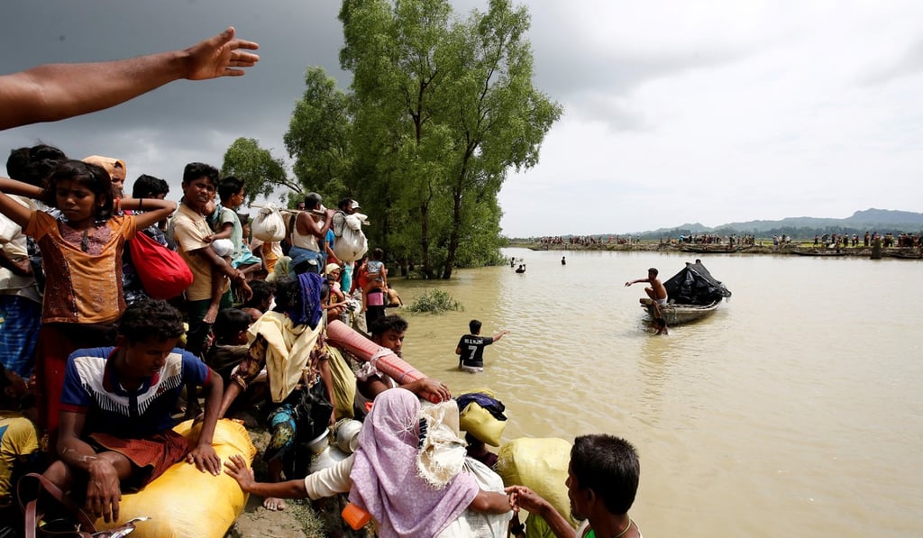 Rohingya refugees wait for boat to cross a canal in Teknaf, Bangladesh. Photo: Reuters
