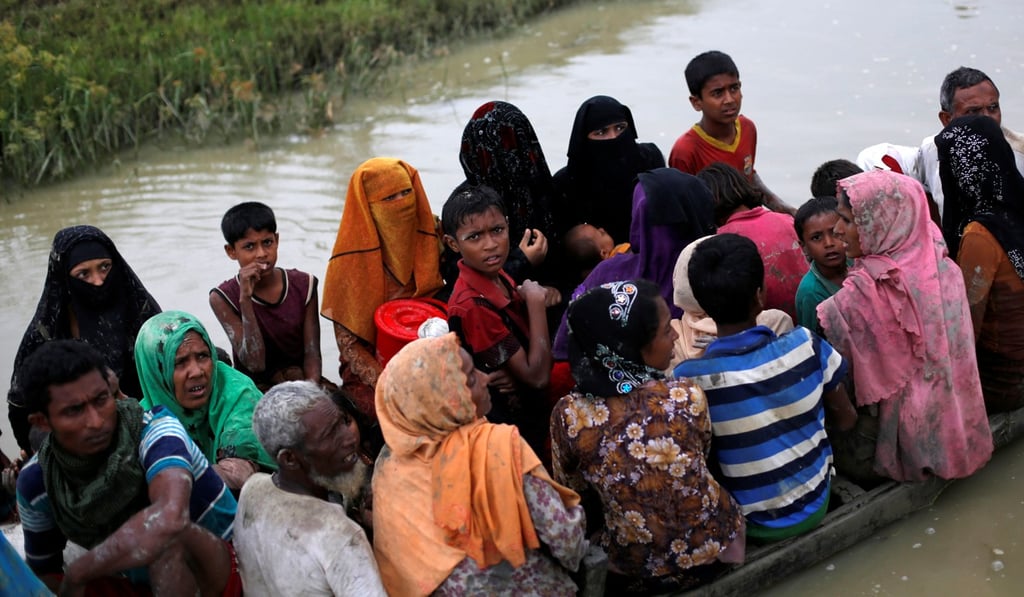 Rohingya ride a boat after crossing the Bangladesh-Myanmar border. Photo: Reuters