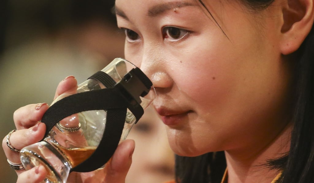 A woman takes a sniff at Whisky Live on Saturday. Whisky Live events in Japan and Taiwan attract around 10,000 people. Photo: David Wong