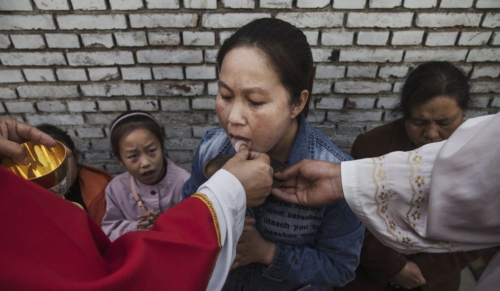 A Chinese Catholic takes communion at an "underground" church. Photo: AFP