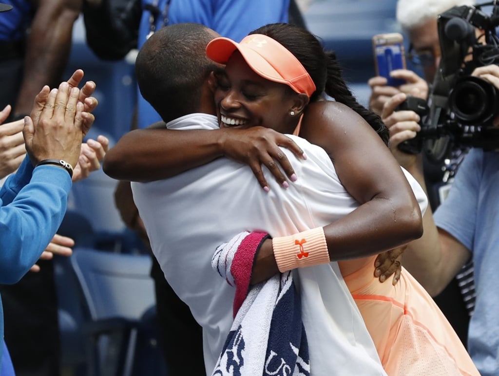 Stephens hugs her coach, Kamau Murray, after beating Keys. Photo: AP