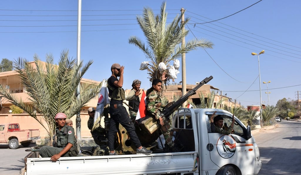 Syrian pro-government forces drive in an armed vehicle in Deir Ezzor on September 10, 2017, as they continue to press forward with Russian air cover in the offensive against Islamic State group jihadists. Photo: AFP
