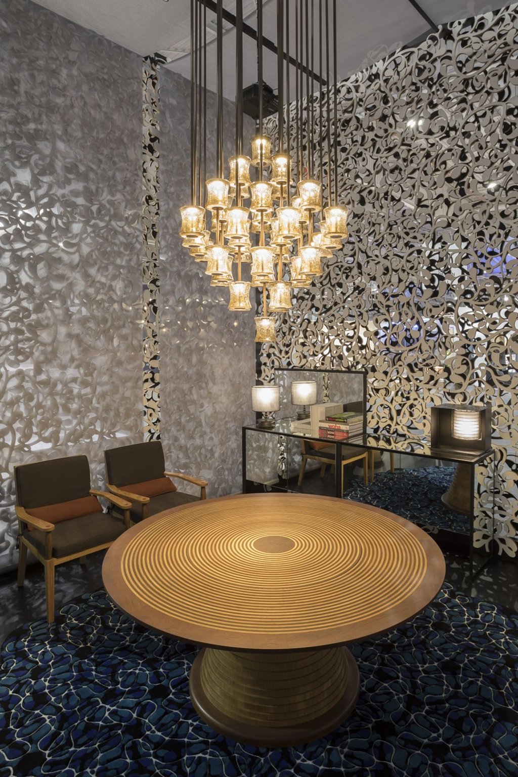 A round wooden table from WOHAbeing’s Ulu collection table, with lamps from the Oli collection above. Photo: Marek Swoboda Photography
