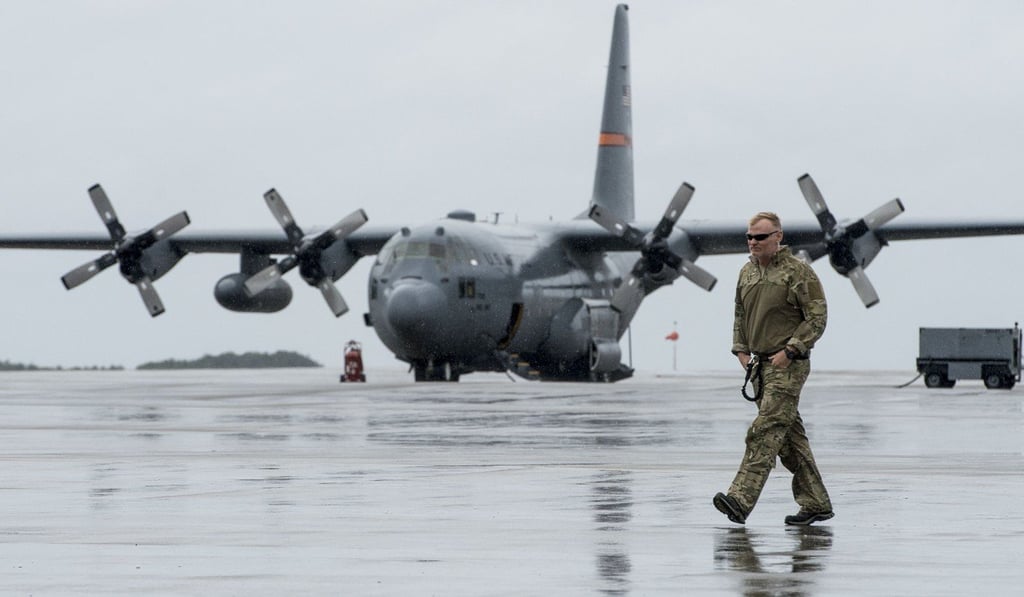 In this handout photo released by the US Air Force, a member from the California National Guard makes his way to a C-130H Hercules from the Texas Air National Guard at Hurlburt Field near Pensacola, Florida on Monday. Photo: AFP