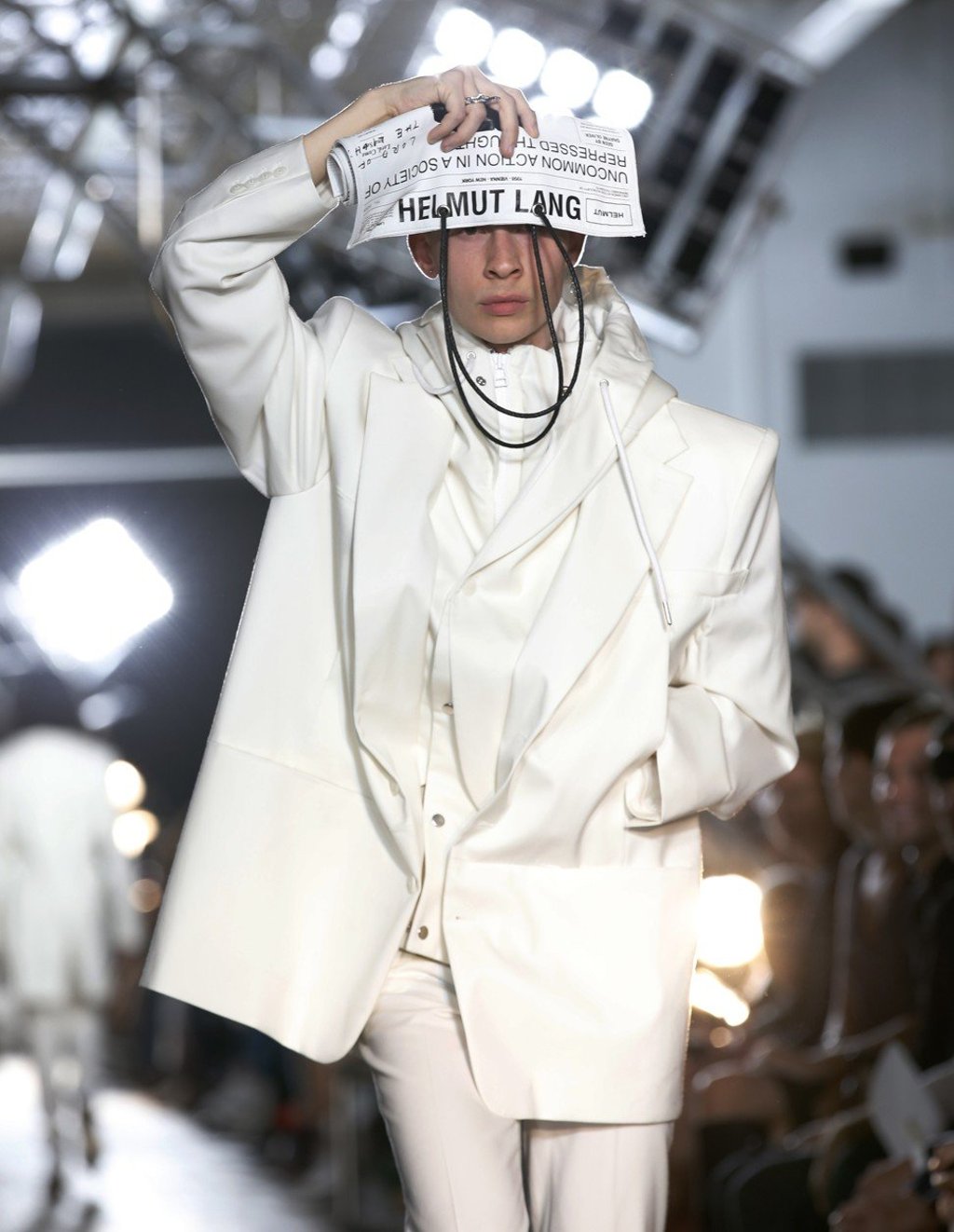 A model shields her eyes with a custom newspaper as she walks the runway at the Helmut Lang Seen by Shayne Oliver show during New York Fashion Week. Photo: AP A model shields her eyes with a custom newspaper as she walks the runway at the Helmut Lang Seen by Shayne Oliver show during New York Fashion Week. Photo: AP